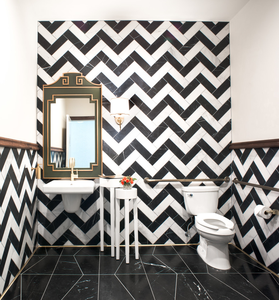 Design ideas for a mid-sized eclectic powder room in San Francisco with stone tile, marble floors, a wall-mount sink, a two-piece toilet and black and white tile.