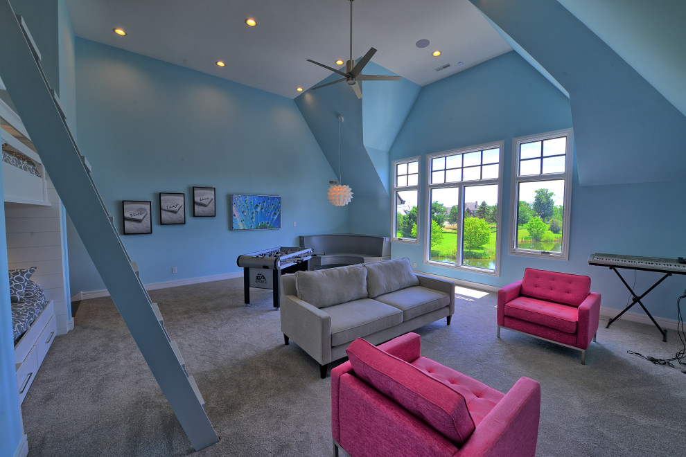 This is an example of an expansive gender neutral playroom in Indianapolis with blue walls, carpet and grey floors.