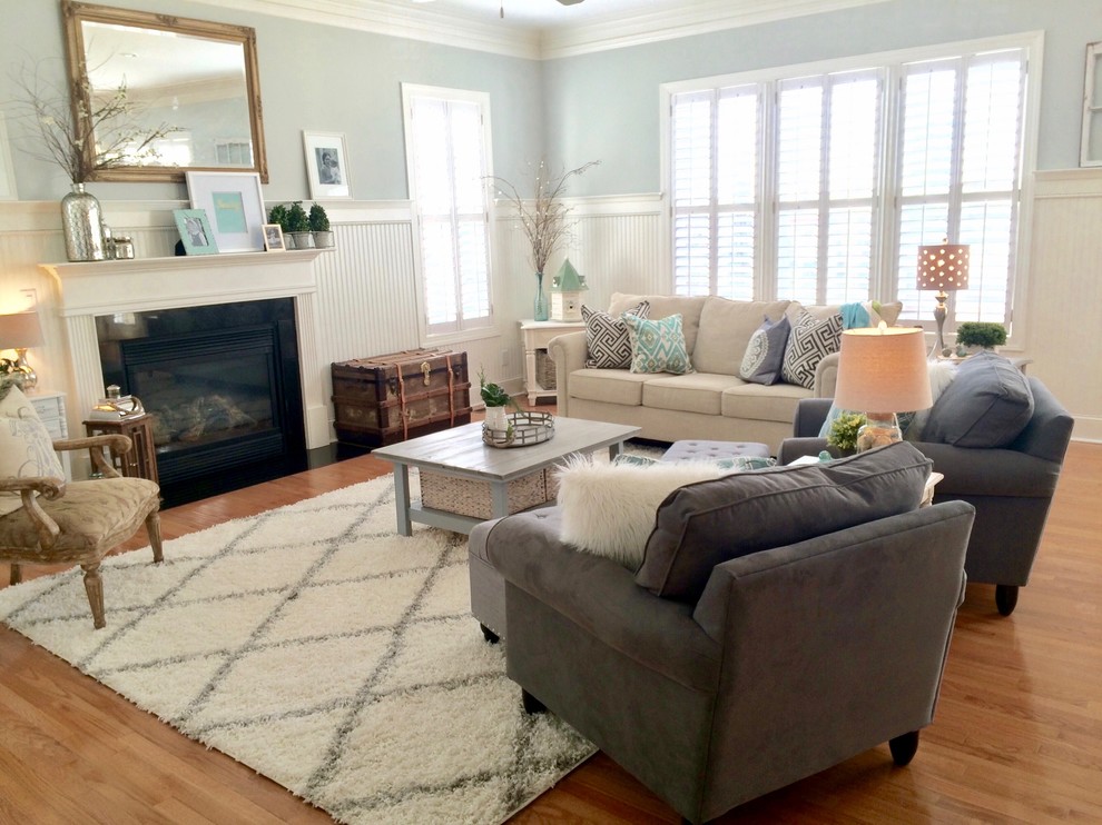 Living room - mid-sized modern open concept medium tone wood floor and brown floor living room idea in Charlotte with gray walls and a standard fireplace