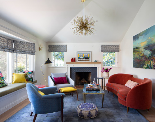 A vibrant living room with a fireplace, a colourful couch, a chair, and a coffee table.