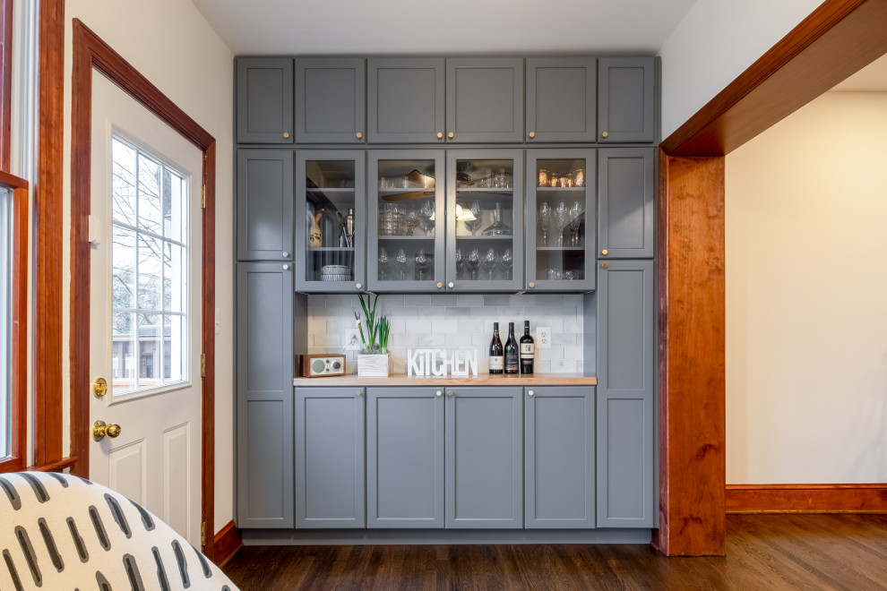 Inspiration for a small modern single-wall kitchen pantry in DC Metro with a single-bowl sink, shaker cabinets, grey cabinets, quartz benchtops, white splashback, ceramic splashback, stainless steel appliances, dark hardwood floors, with island, brown floor and white benchtop.