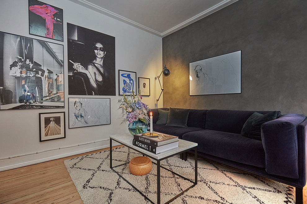 Photo of a contemporary living room in Copenhagen with grey walls, light hardwood floors and beige floor.