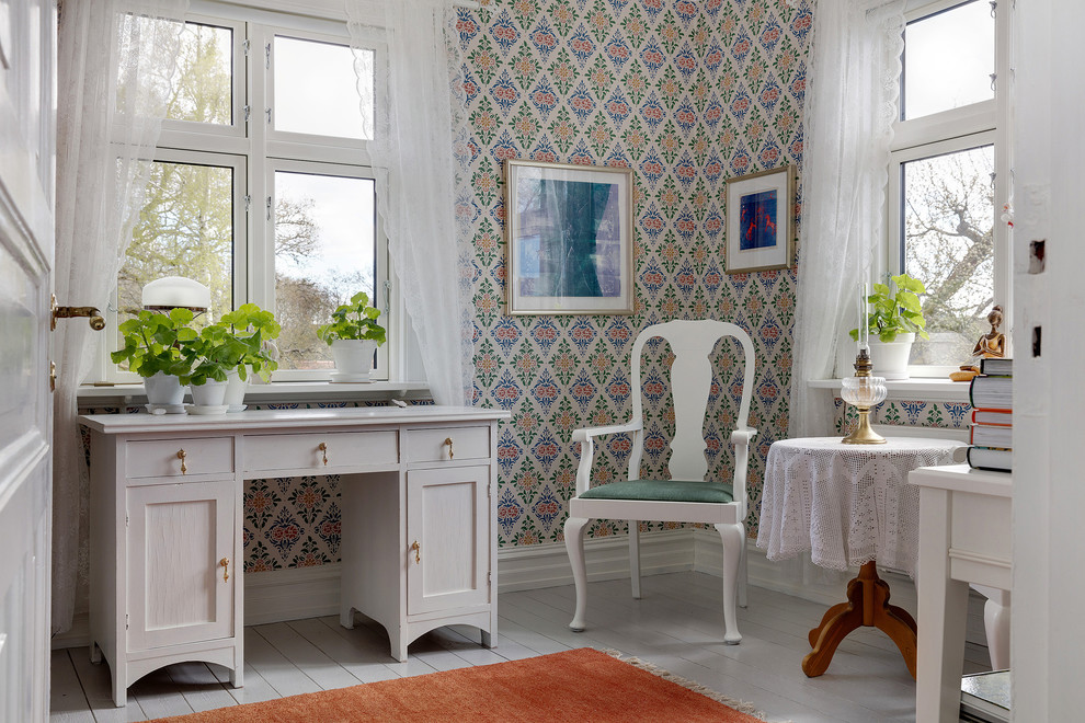 Country home office in Gothenburg with multi-coloured walls, painted wood floors, a freestanding desk and white floor.