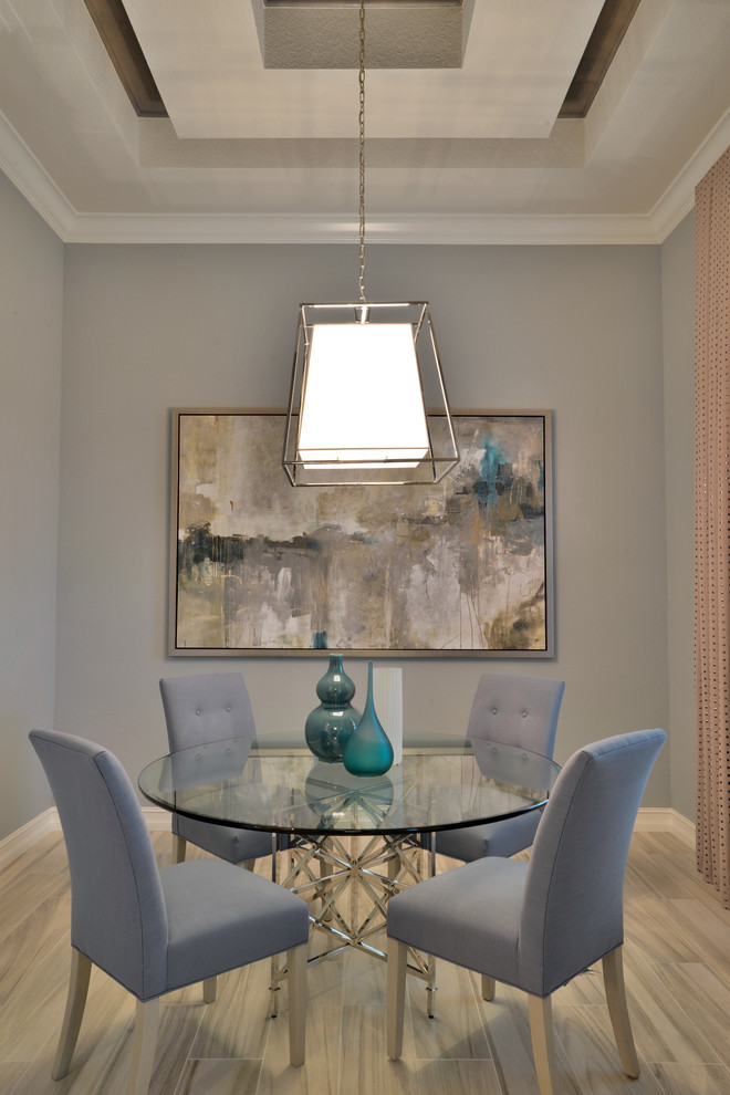 Design ideas for a transitional dining room in Miami with grey walls and light hardwood floors.
