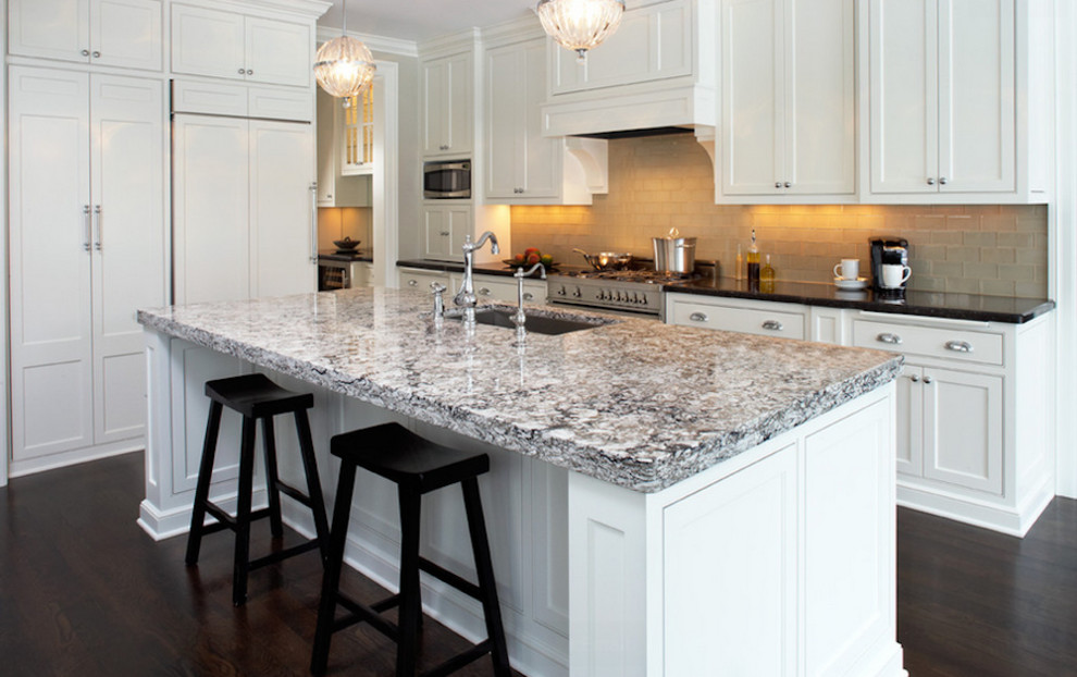 Mid-sized transitional l-shaped dark wood floor and brown floor enclosed kitchen photo in Toronto with an undermount sink, recessed-panel cabinets, white cabinets, concrete countertops, white backsplash, ceramic backsplash, stainless steel appliances and a peninsula
