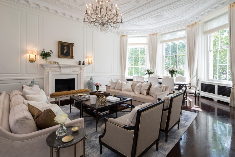 Photo of a large traditional formal enclosed living room in London with white walls, dark hardwood floors, a standard fireplace and a stone fireplace surround.
