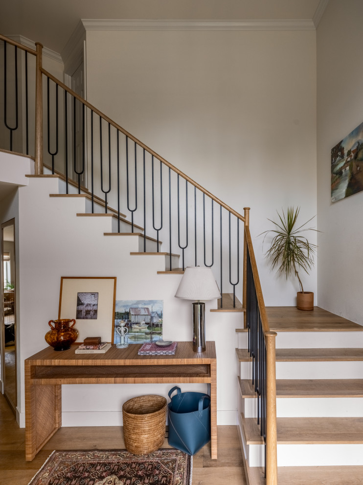 Inspiration for a transitional wooden l-shaped metal railing staircase remodel in Seattle with painted risers