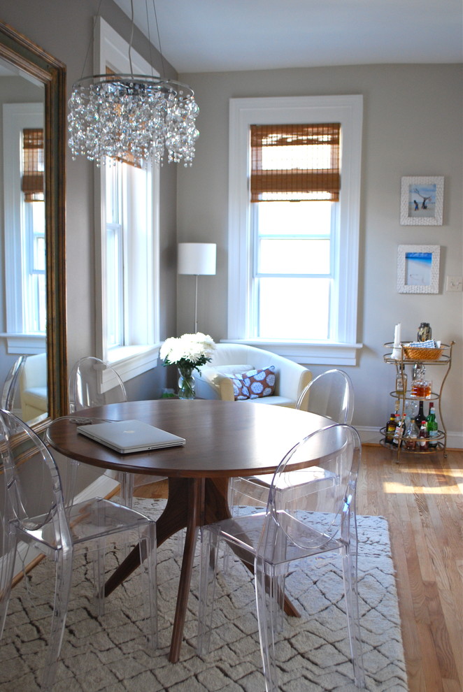 Photo of an eclectic dining room in DC Metro with grey walls and medium hardwood floors.