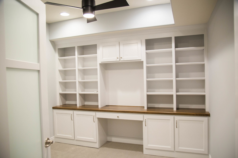 Design ideas for a mid-sized arts and crafts study room in Indianapolis with a built-in desk.
