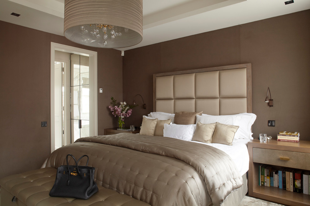 Inspiration for a contemporary master bedroom in London with brown walls and carpet.