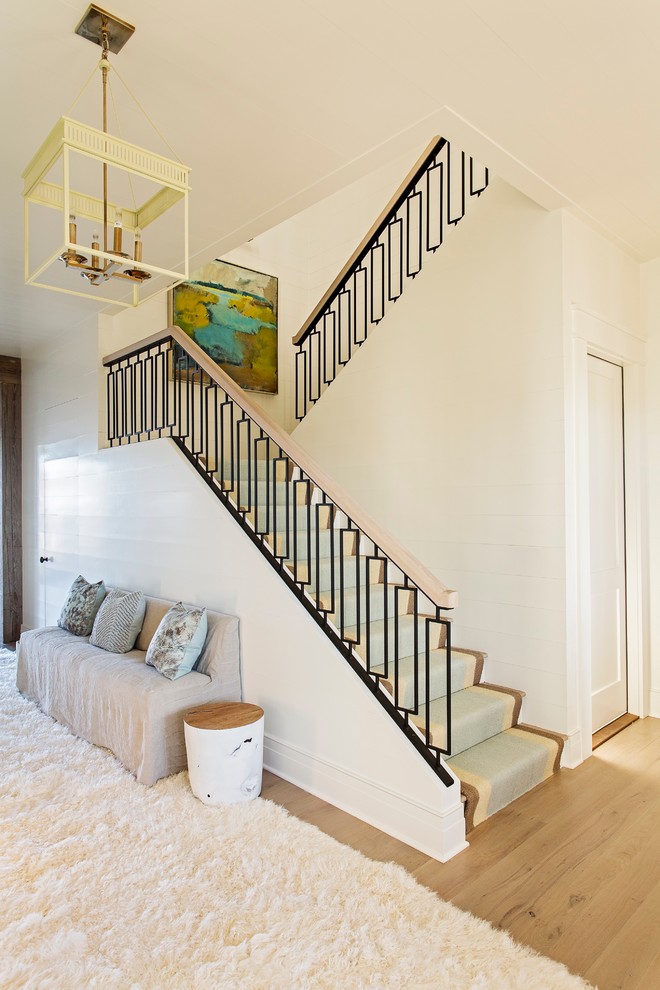 Mid-sized contemporary carpeted l-shaped staircase in Charleston with metal railing.