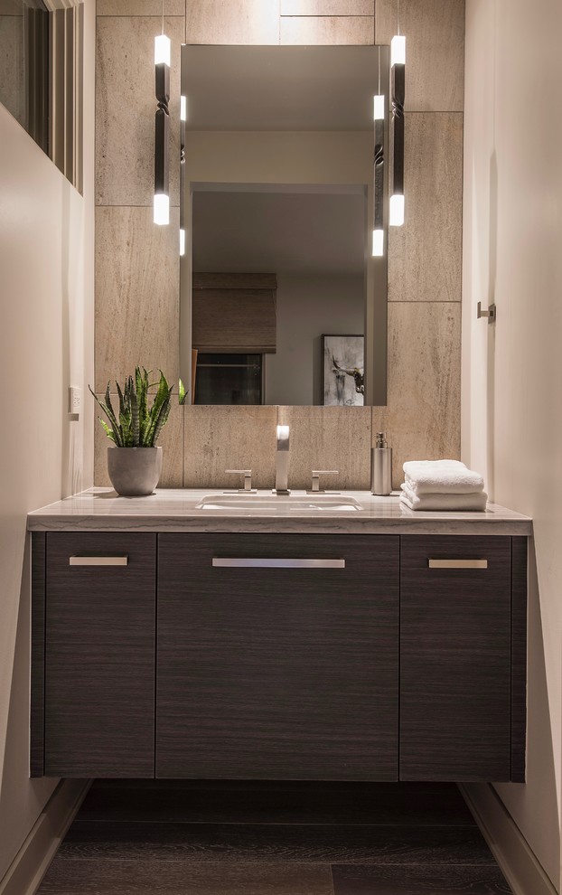 Inspiration for a large contemporary 3/4 bathroom in Phoenix with flat-panel cabinets, grey cabinets, a curbless shower, a one-piece toilet, beige tile, limestone, beige walls, medium hardwood floors, an undermount sink, quartzite benchtops, beige floor, an open shower and white benchtops.