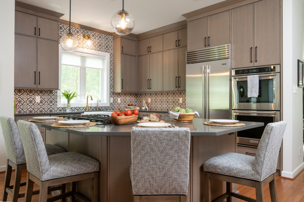 Inspiration for a mediterranean medium tone wood floor eat-in kitchen remodel in Baltimore with an island, multicolored backsplash, stainless steel appliances, gray countertops, light wood cabinets and cement tile backsplash