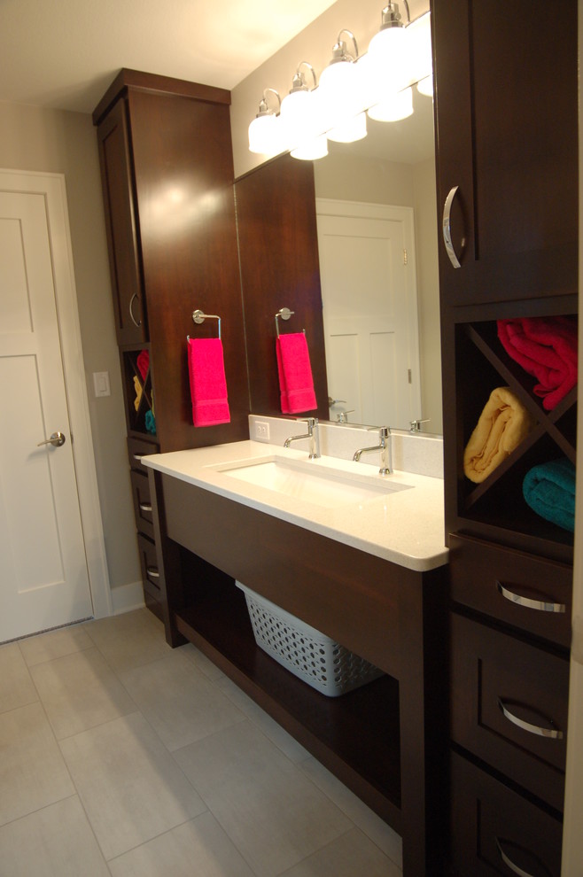 Small transitional kids' gray tile and glass tile porcelain tile alcove bathtub photo with an undermount sink, furniture-like cabinets, dark wood cabinets, quartz countertops, a two-piece toilet and gray walls
