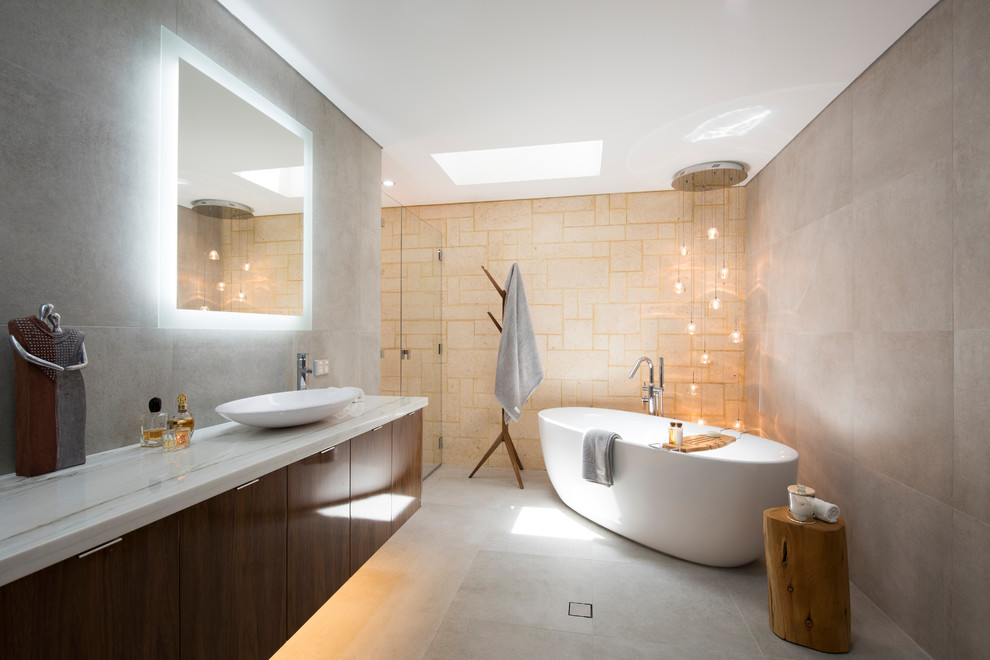 Large country master bathroom in Perth with dark wood cabinets, a freestanding tub, an alcove shower, a wall-mount toilet, multi-coloured tile, porcelain tile, multi-coloured walls, porcelain floors, a vessel sink and solid surface benchtops.