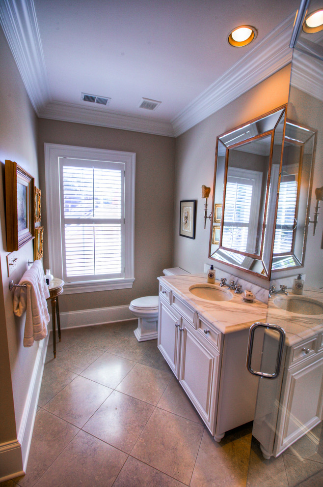 Example of a mid-sized transitional master gray tile, white tile and stone slab marble floor freestanding bathtub design in Charlotte with shaker cabinets, white cabinets, a two-piece toilet, white walls, an undermount sink and marble countertops