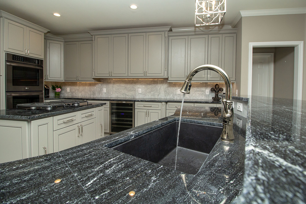 Example of a large transitional l-shaped porcelain tile and white floor eat-in kitchen design in Houston with a single-bowl sink, beaded inset cabinets, gray cabinets, granite countertops, white backsplash, marble backsplash, stainless steel appliances, two islands and black countertops