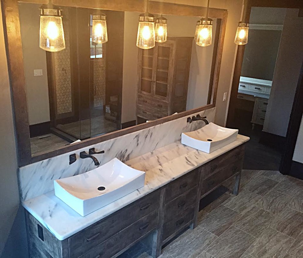 This is an example of a mid-sized country master bathroom in Chicago with flat-panel cabinets, grey cabinets, a one-piece toilet, beige tile, porcelain tile, beige walls, porcelain floors, a vessel sink and quartzite benchtops.
