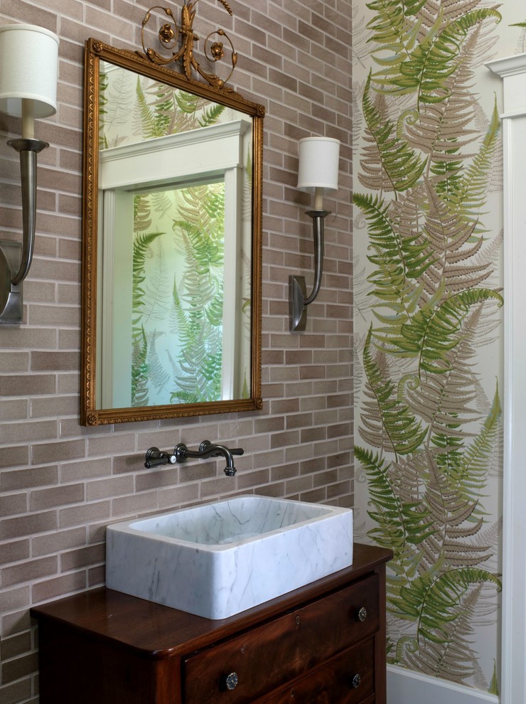 Photo of a mid-sized traditional powder room in San Francisco with a vessel sink, ceramic tile, wood benchtops, dark wood cabinets, green walls, furniture-like cabinets, gray tile and brown benchtops.
