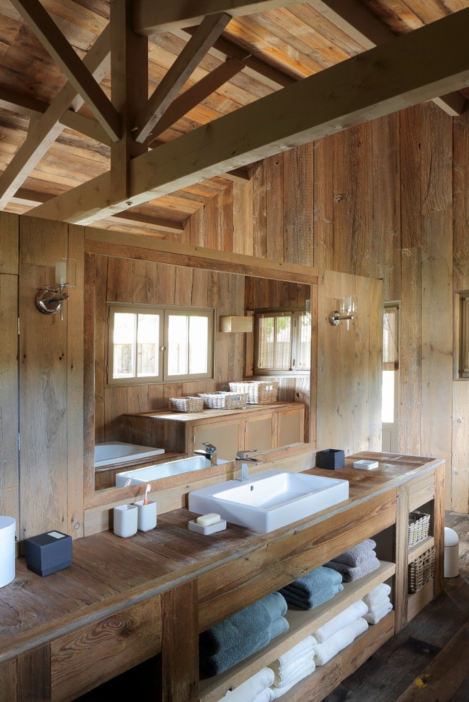 Inspiration for a country bathroom in Other with wood benchtops.