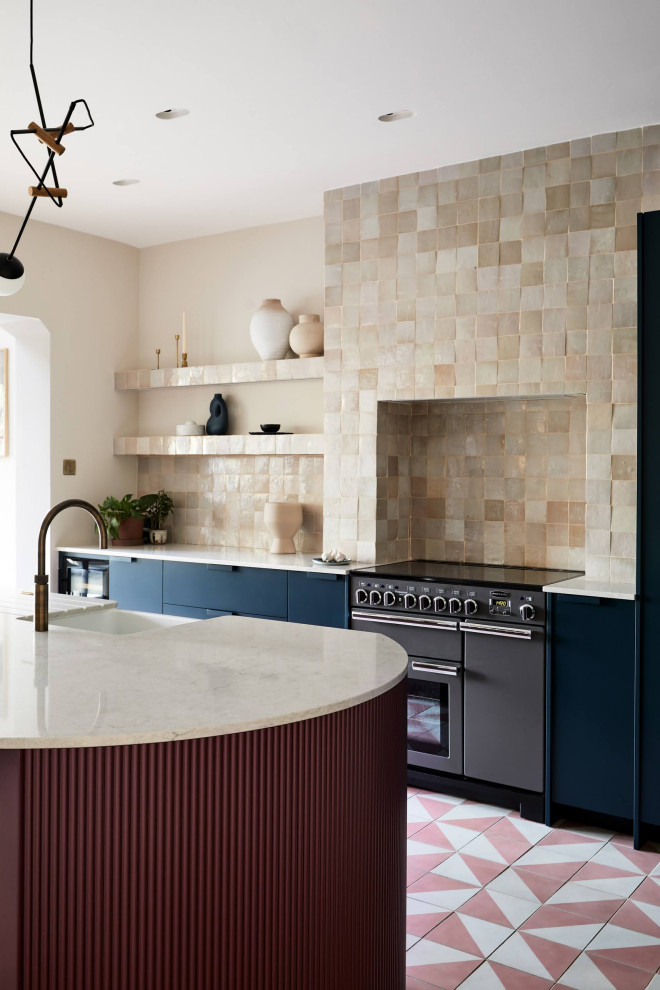 Photo of a large contemporary l-shaped eat-in kitchen in London with blue cabinets, cement tiles, with island and pink floor.