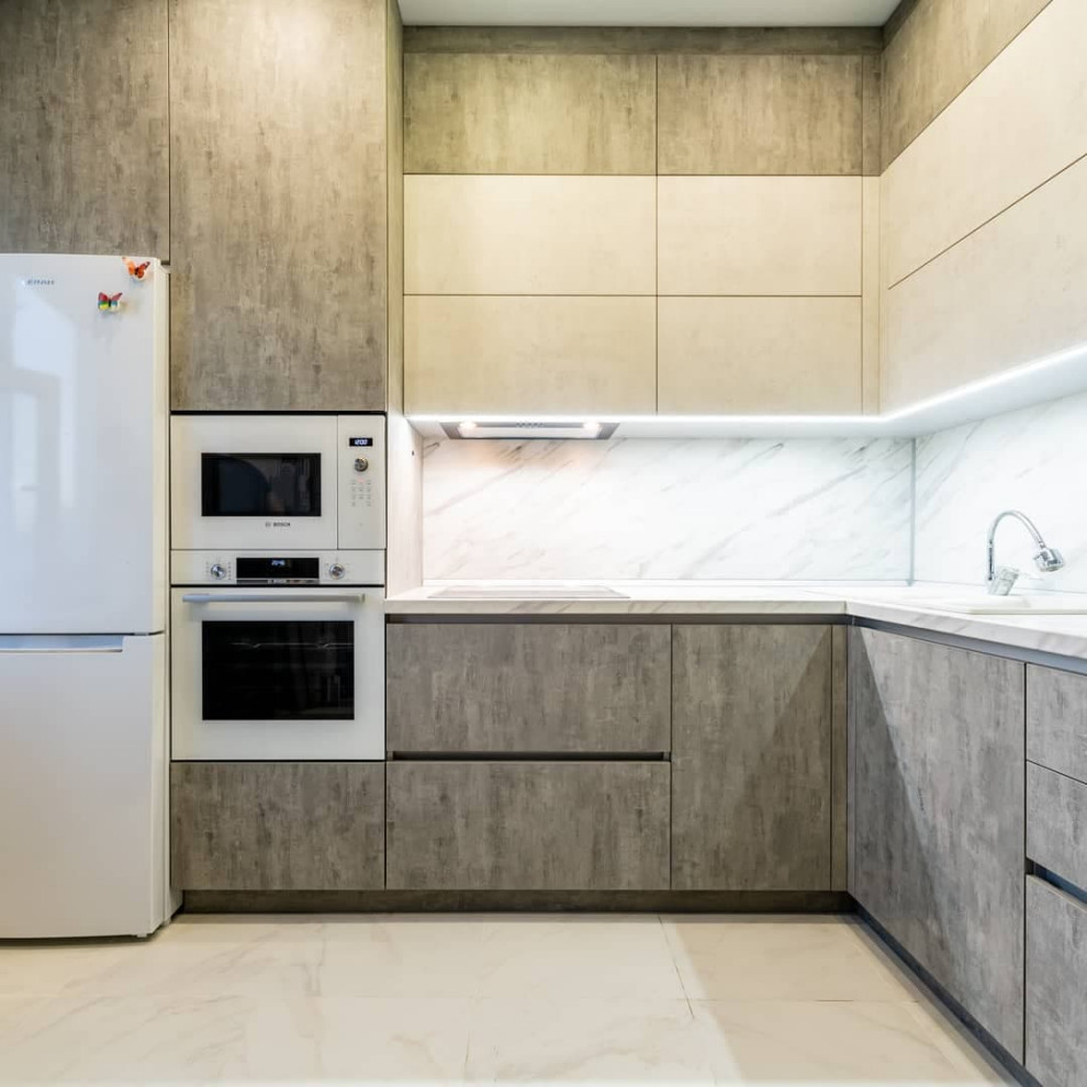 Mid-sized industrial l-shaped eat-in kitchen in Moscow with a drop-in sink, recessed-panel cabinets, stainless steel cabinets, solid surface benchtops, white splashback, granite splashback, stainless steel appliances, porcelain floors, no island, white floor and white benchtop.