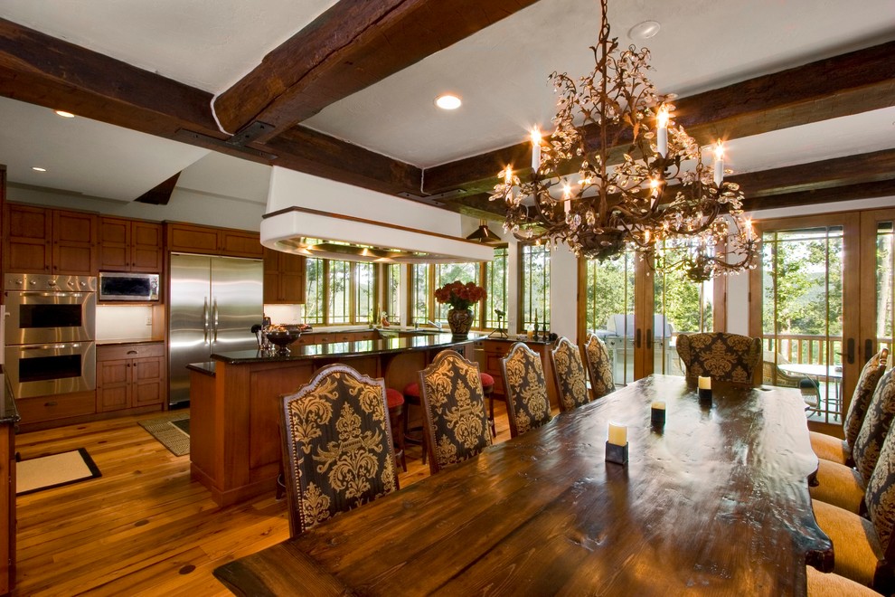 This is an example of a large country kitchen/dining combo in Other with white walls and medium hardwood floors.