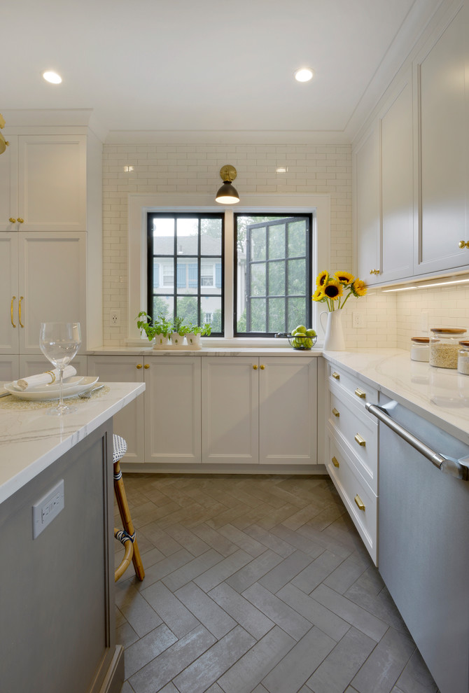 Enclosed kitchen - small transitional u-shaped porcelain tile and gray floor enclosed kitchen idea in New York with an undermount sink, recessed-panel cabinets, white cabinets, quartz countertops, white backsplash, ceramic backsplash, stainless steel appliances, an island and white countertops