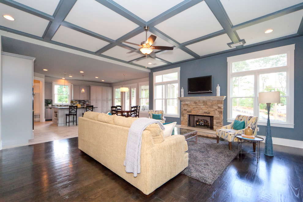 Expansive transitional open concept family room in Atlanta with grey walls, dark hardwood floors, a standard fireplace, a stone fireplace surround and a wall-mounted tv.