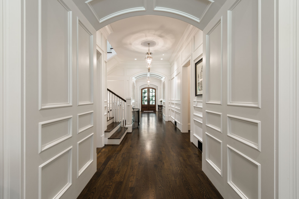 Inspiration for a traditional hallway in Atlanta with white walls and dark hardwood floors.