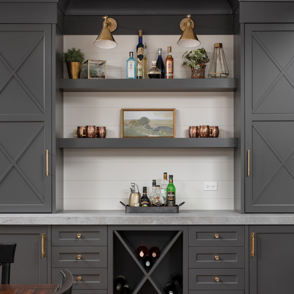 Design ideas for a large transitional u-shaped home bar in Chicago with shaker cabinets, white cabinets, quartzite benchtops, grey splashback, marble splashback, dark hardwood floors, brown floor and white benchtop.