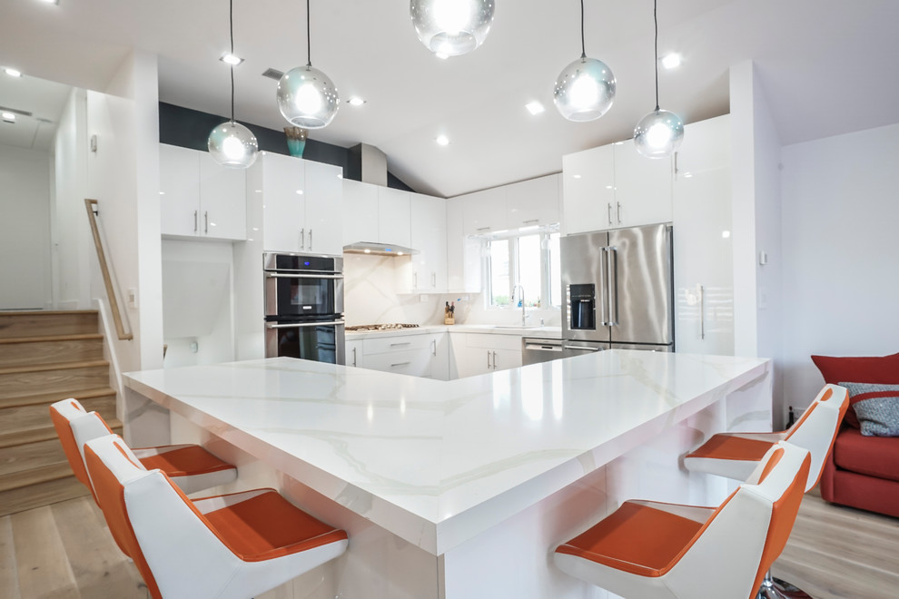 Inspiration for a large contemporary galley eat-in kitchen in New York with an undermount sink, flat-panel cabinets, white cabinets, quartz benchtops, multi-coloured splashback, stone slab splashback, stainless steel appliances, porcelain floors, multiple islands, black floor and white benchtop.