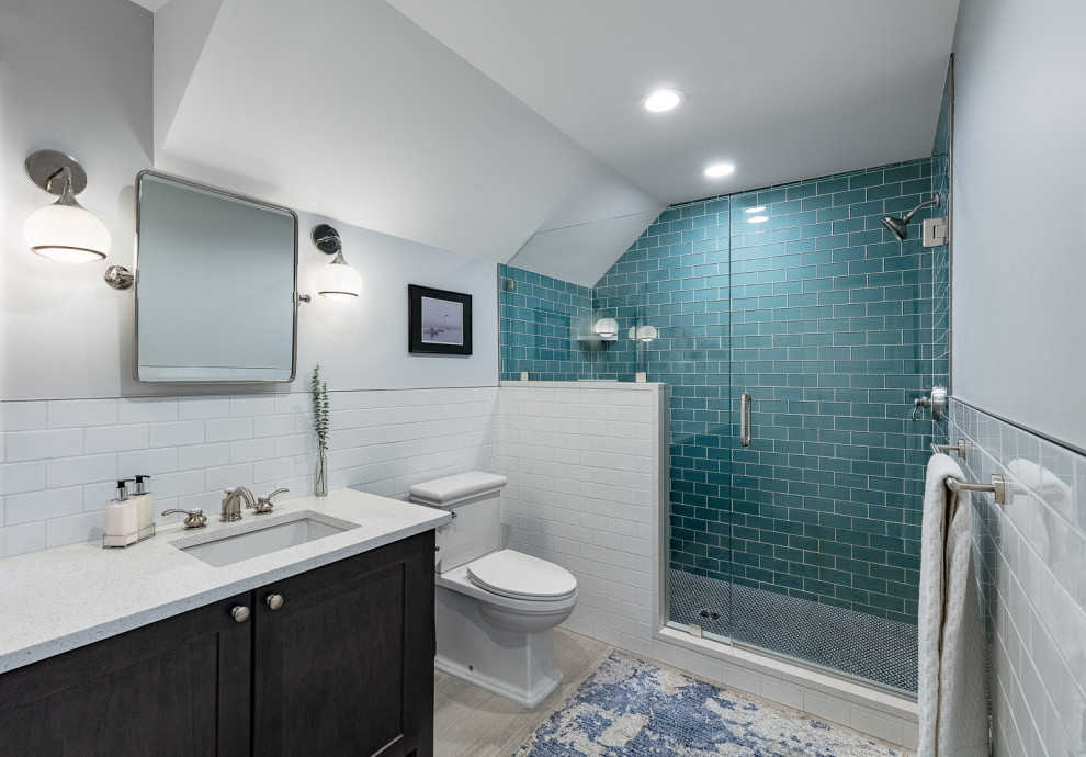 Design ideas for a mid-sized arts and crafts master bathroom in Detroit with shaker cabinets, dark wood cabinets, a freestanding tub, white tile, white walls, an undermount sink, a hinged shower door, white benchtops, a double vanity, a built-in vanity and vaulted.