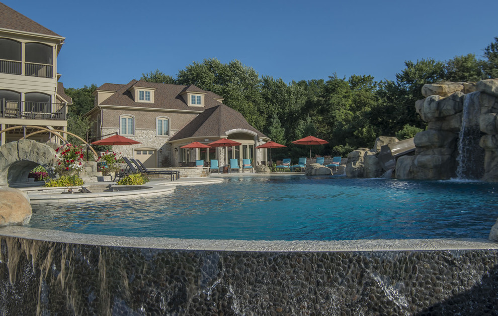 Inspiration for a huge backyard stone and custom-shaped infinity water slide remodel in Chicago