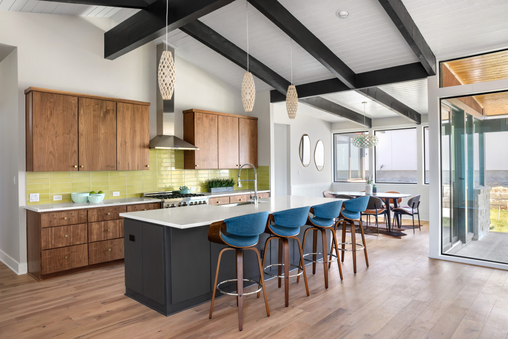 Mid-sized mid-century modern galley medium tone wood floor and beige floor open concept kitchen photo in Austin with an undermount sink, flat-panel cabinets, quartzite countertops, green backsplash, subway tile backsplash, stainless steel appliances, an island and white countertops