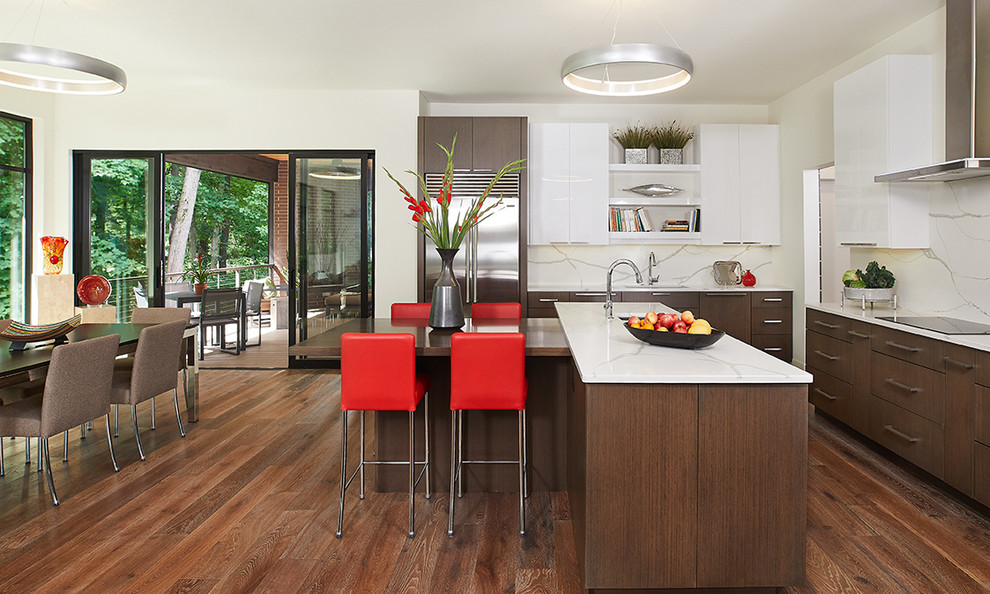 Design ideas for a large contemporary eat-in kitchen in Grand Rapids with an undermount sink, flat-panel cabinets, dark wood cabinets, quartz benchtops, white splashback, marble splashback, stainless steel appliances, brown floor, white benchtop and dark hardwood floors.