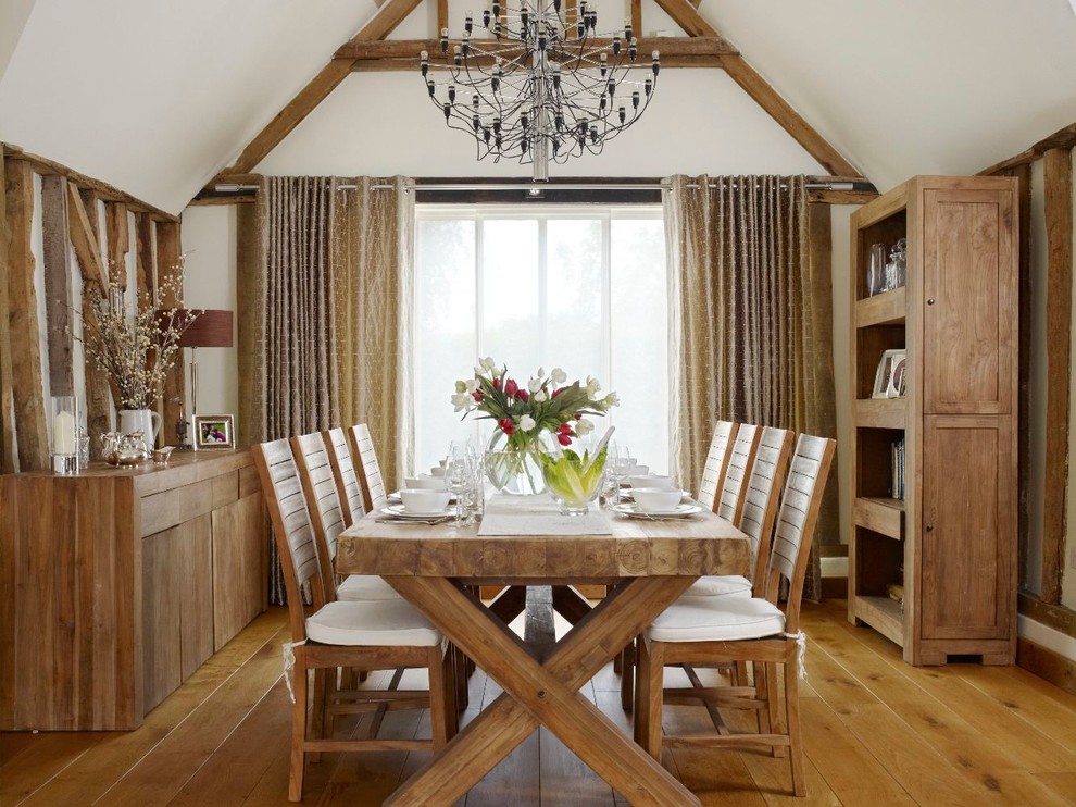 Photo of a large country dining room in Hertfordshire with white walls and medium hardwood floors.