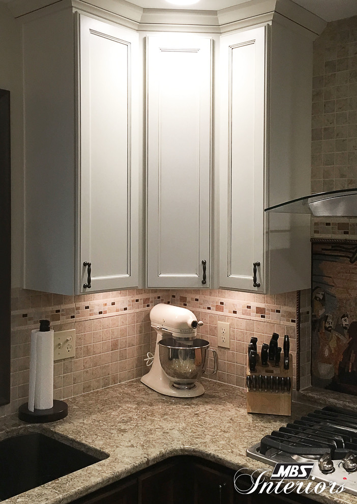 Small transitional u-shaped eat-in kitchen photo with an undermount sink, recessed-panel cabinets, white cabinets, quartzite countertops, multicolored backsplash, mosaic tile backsplash, stainless steel appliances and no island