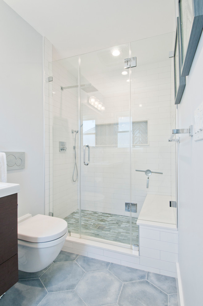 Design ideas for a mid-sized contemporary master bathroom in Los Angeles with flat-panel cabinets, dark wood cabinets, an alcove shower, a one-piece toilet, blue tile, glass tile, white walls, porcelain floors, an integrated sink, quartzite benchtops, blue floor, a hinged shower door and white benchtops.