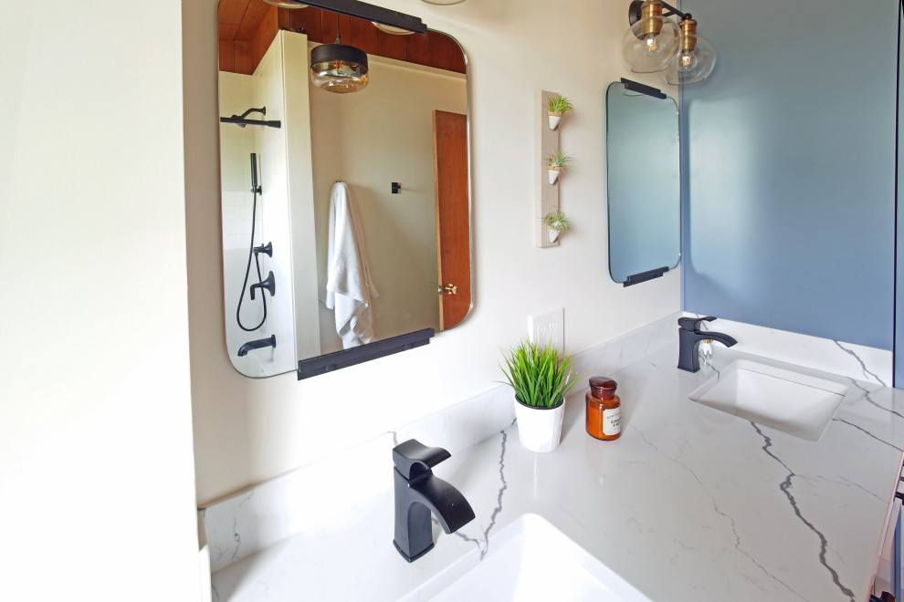 Photo of a small midcentury master bathroom in Tampa with flat-panel cabinets, blue cabinets, an alcove tub, an alcove shower, gray tile, porcelain floors, an undermount sink, engineered quartz benchtops, grey floor, a shower curtain and white benchtops.