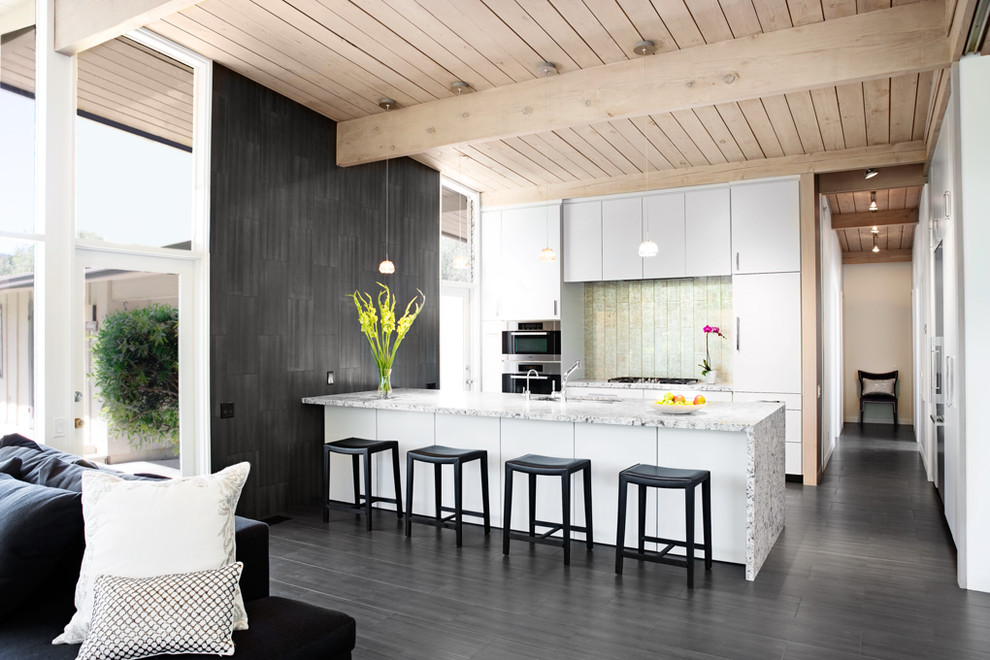 Design ideas for a midcentury kitchen in Santa Barbara with flat-panel cabinets, white cabinets, metallic splashback and stainless steel appliances.