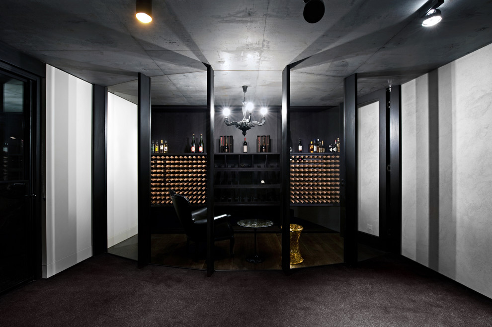 Photo of a mid-sized contemporary wine cellar in Adelaide with carpet, storage racks and grey floor.