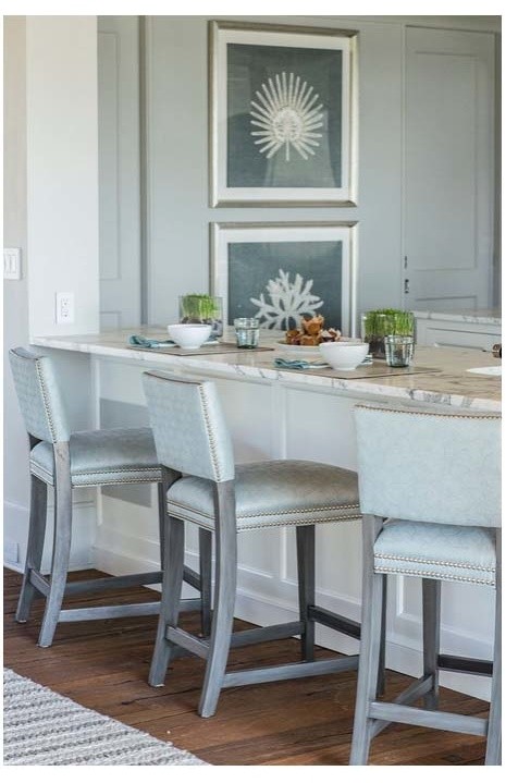 Inspiration for a transitional kitchen in New York with white cabinets, marble benchtops and medium hardwood floors.