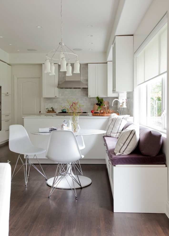 This is an example of a transitional open plan dining in Vancouver with white walls and dark hardwood floors.