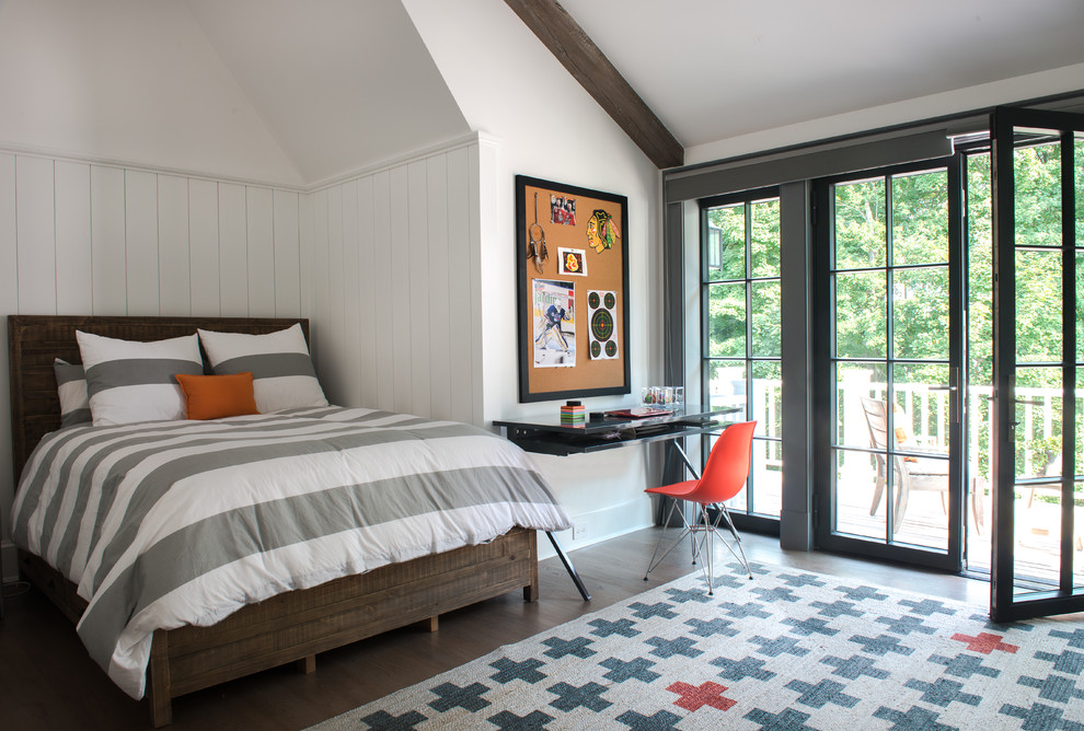 This is an example of a transitional kids' room for boys in New York with dark hardwood floors and white walls.