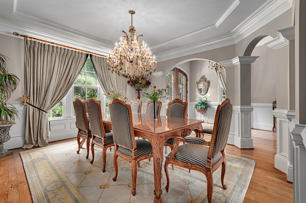 Photo of a traditional separate dining room in Other with grey walls and medium hardwood floors.
