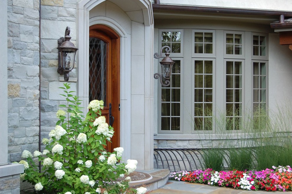 Photo of a traditional exterior in Chicago with stone veneer.