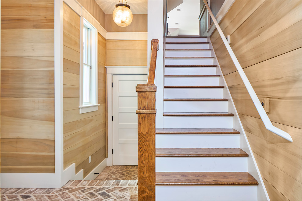 Photo of a transitional wood straight staircase in Charleston with painted wood risers.