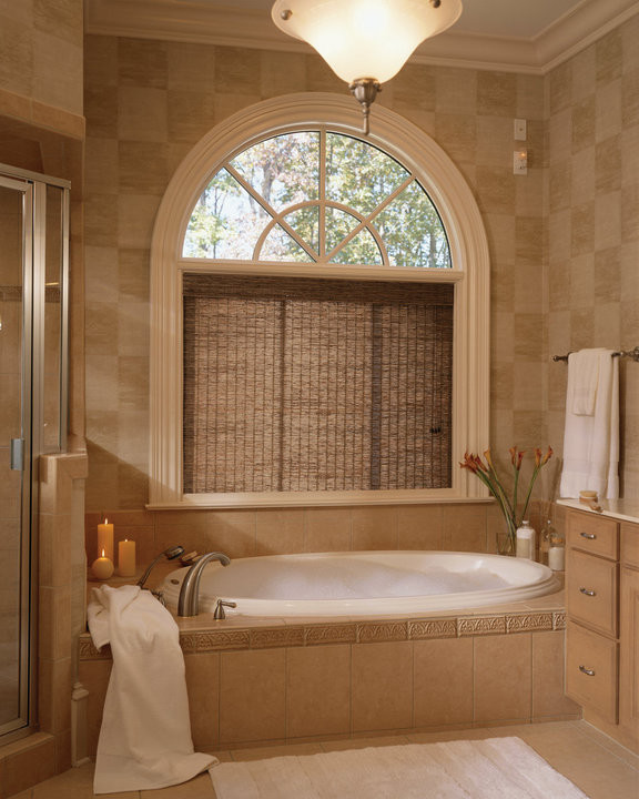 Photo of a mid-sized transitional master bathroom in Other with flat-panel cabinets, light wood cabinets, a drop-in tub, a corner shower, beige tile, ceramic tile, beige walls, ceramic floors and an undermount sink.