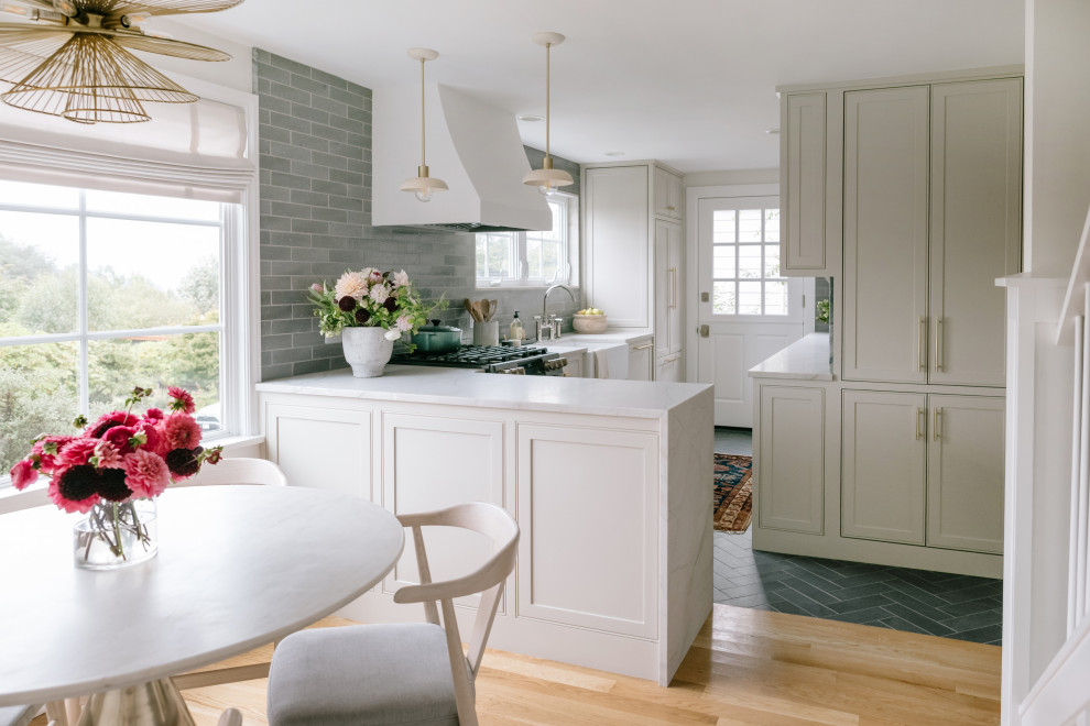 Small elegant l-shaped porcelain tile and gray floor eat-in kitchen photo in Seattle with a farmhouse sink, beaded inset cabinets, gray cabinets, quartz countertops, green backsplash, ceramic backsplash, black appliances, a peninsula and white countertops